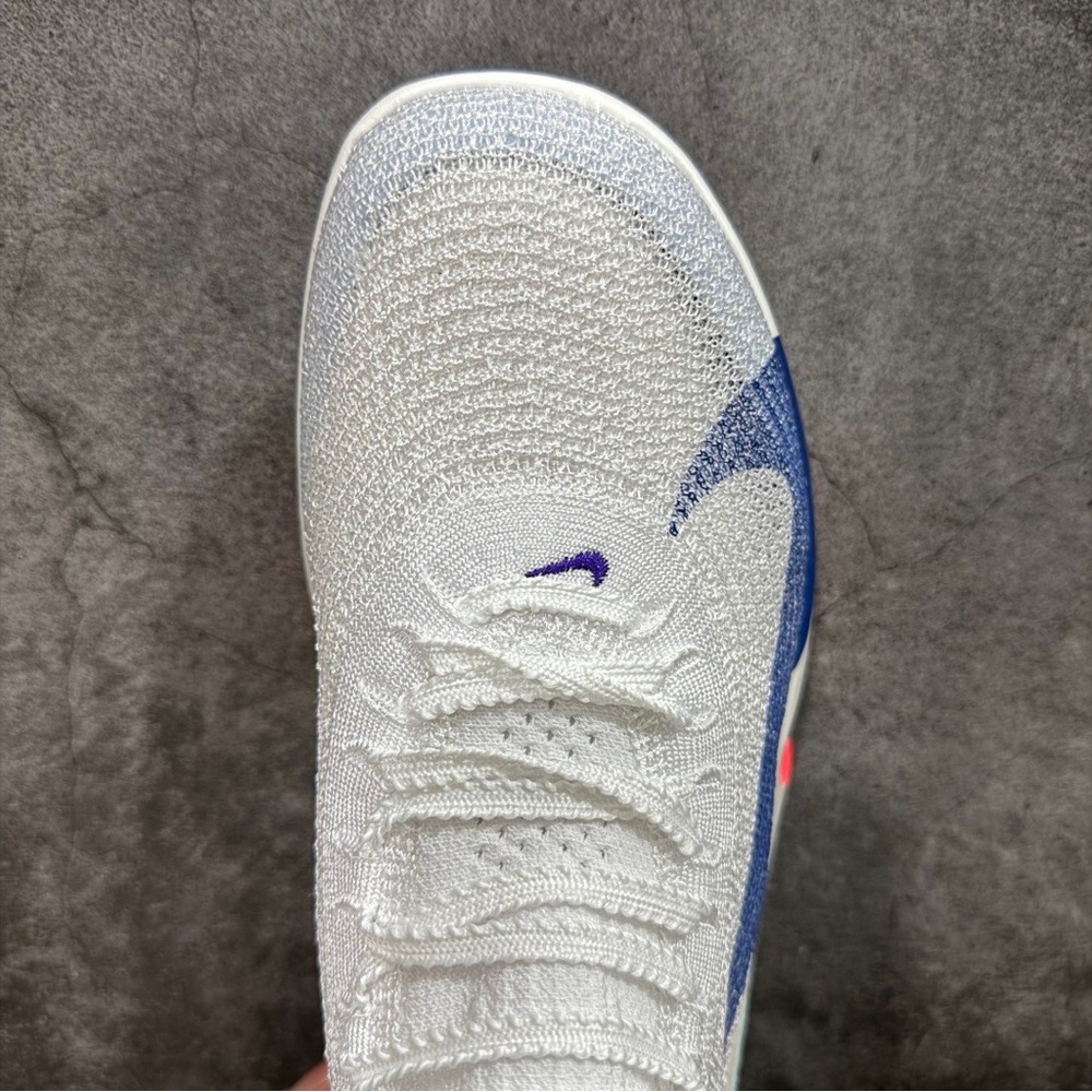 Nike Flyknit White Athletic Shoe with Blue Accent
